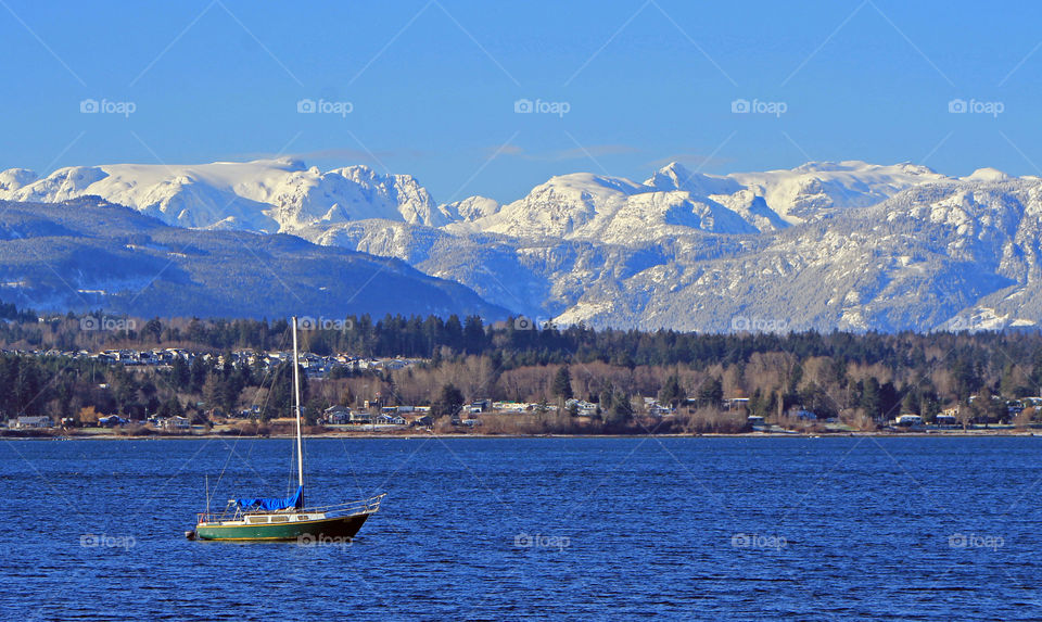 It was a beautiful sunny winter day which is rare on the Pacific North ‘wet’ Coast. This shot was taken from the waterfront pier & shows the panoramic view of the estuary, (complete with sailboat), the town, the hills, mountains & blue cloudless sky!