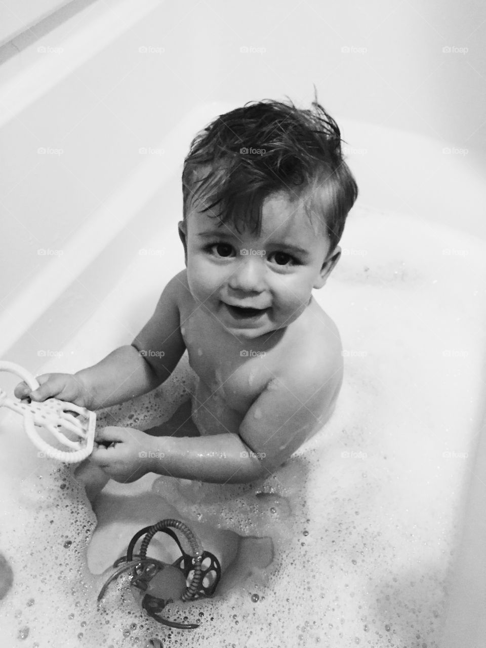 High angle view of boy bathing in bathtub