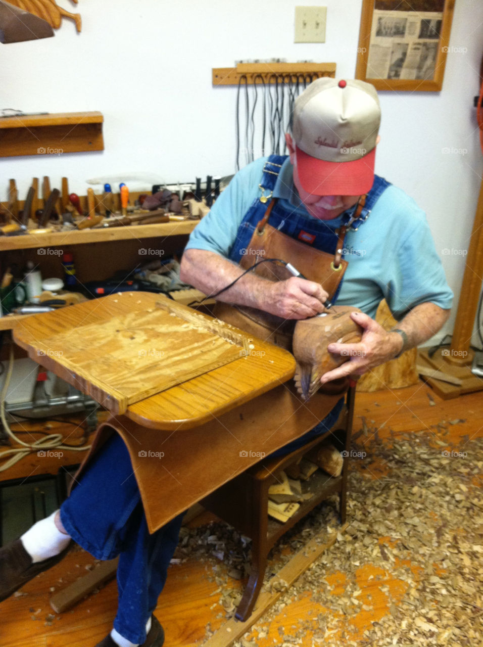 Wood carver at work in his shop