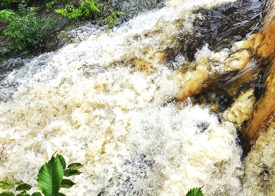 Flood waters bursting over the duck ponds weir
