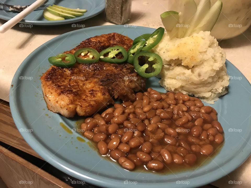 Pork chops, mashed potatoes, baked beans topped with jalapeño and Granny Smith apples
