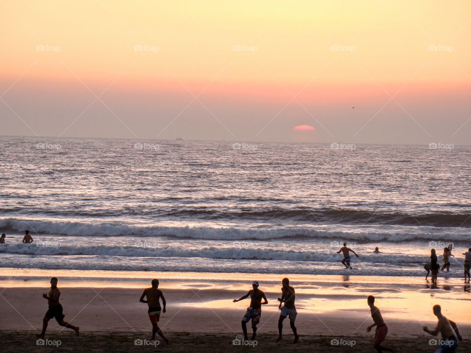 Playing football by Indian Ocean, GOA, India