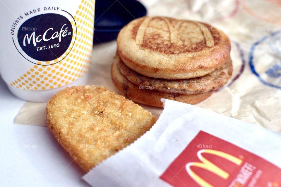 McDonald’s Mc Café sausage McGriddle hash brown close up side flat lay