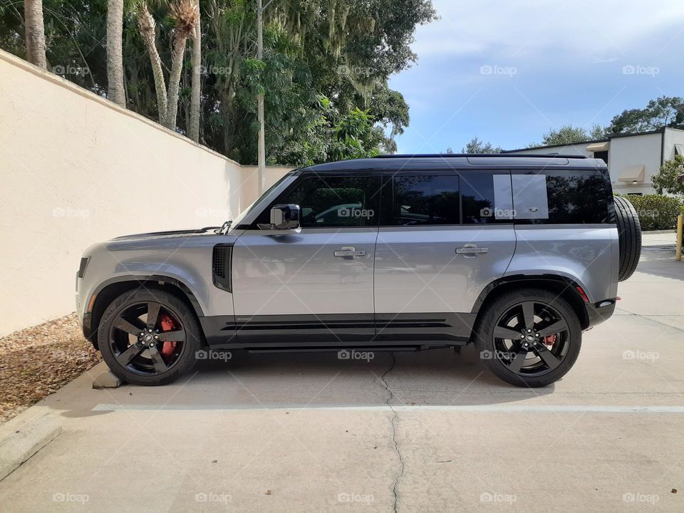 A silver and black motor vehicle sits in a parking space at an office building in Florida.