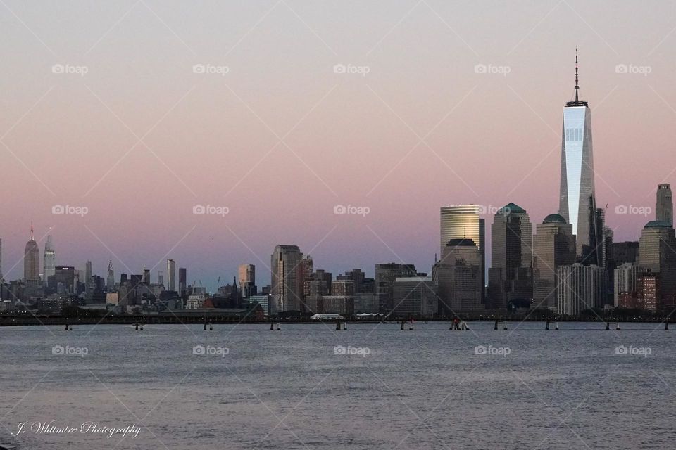 The last light of day reflects off Freedom Tower, built to replace the Twin Towers brought down on 9-11, while the famous Empire State Building looms in the left corner