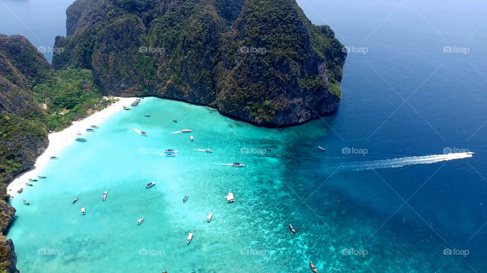 Stunning turquoise sea and boats at Lipe Island in Thailand , aerial view