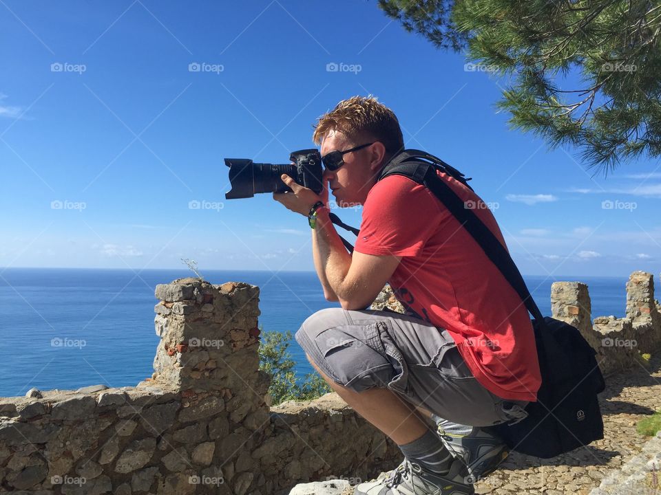 Male tourist taking pictures in Cefalu on Sicily.