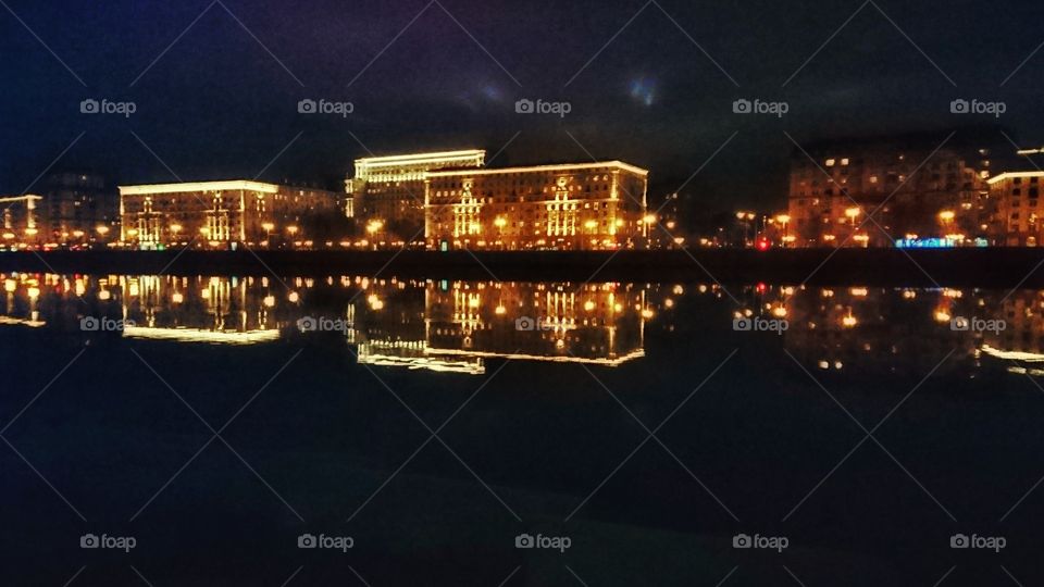 Moscow night city lights reflected in the river