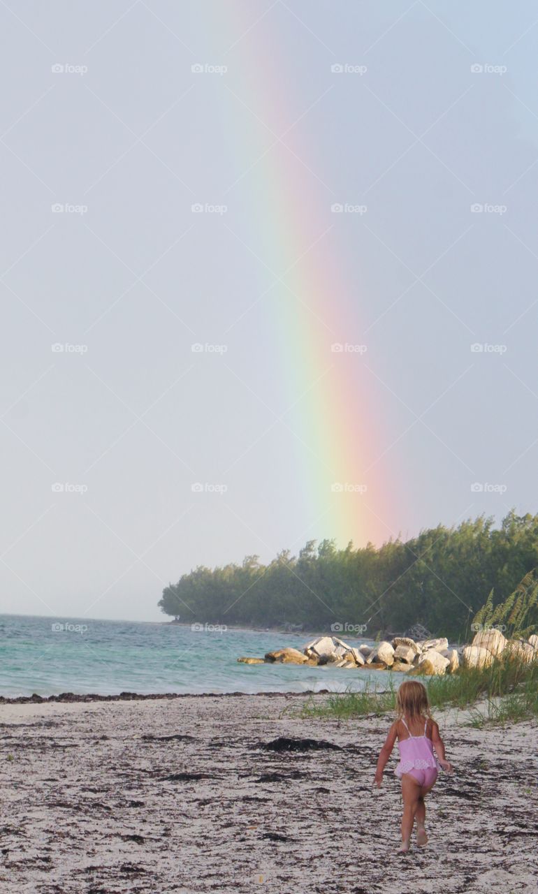 Toddler a rainbow at the beach