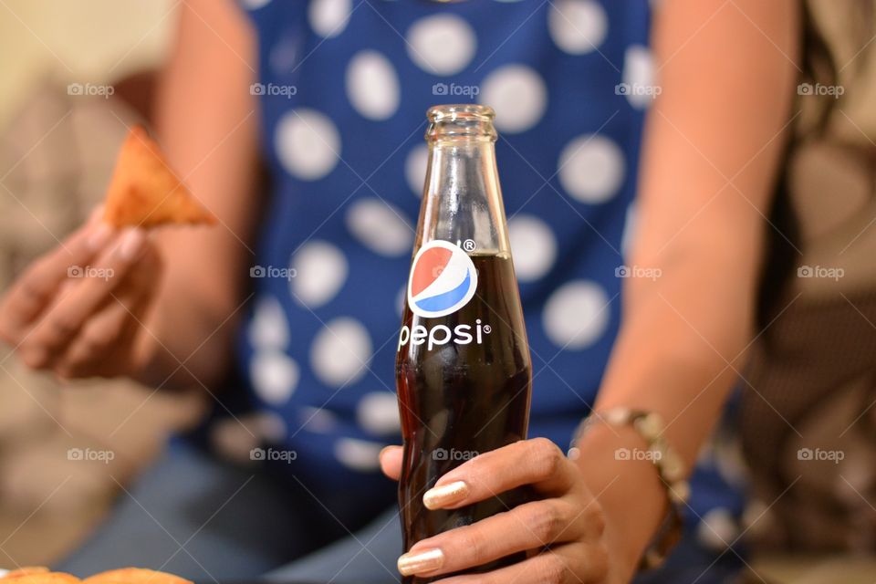 Enjoying Pepsi with snacks