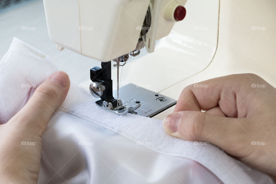 Woman sewing on sewing machine