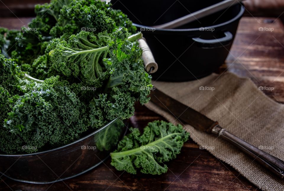 Fresh Kale on rustic background 