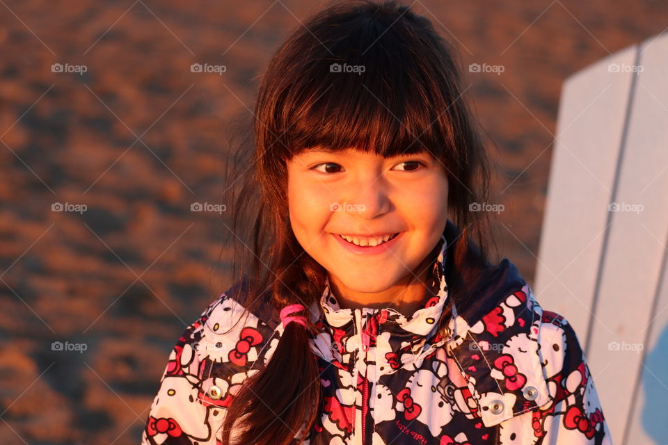 Golden hour by the lake, portrait of a little girl