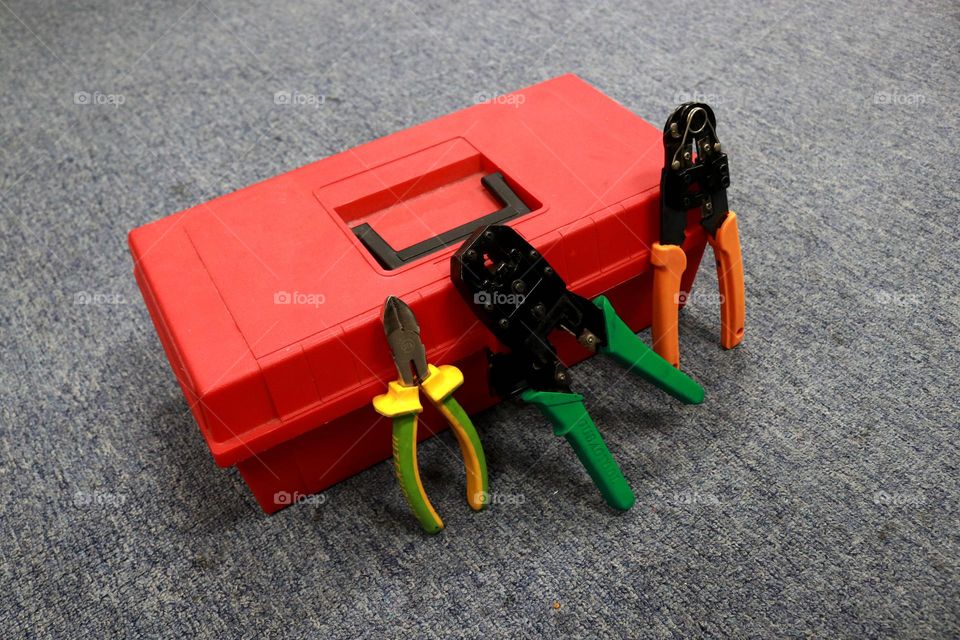 red toolbox contains various tools to work on or fix something