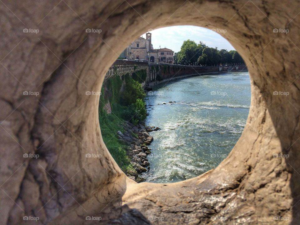 View of Verona city through rock frame