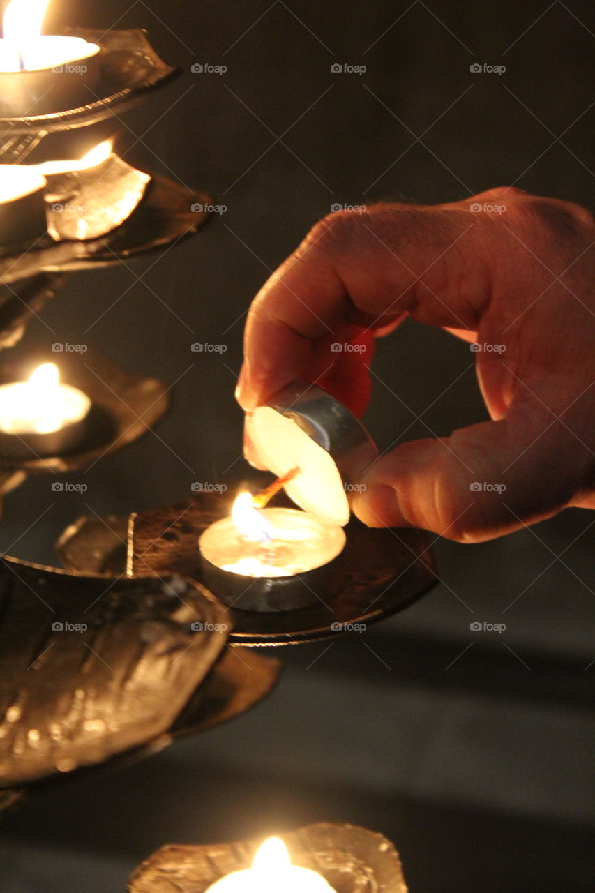 Candles, flame and hand