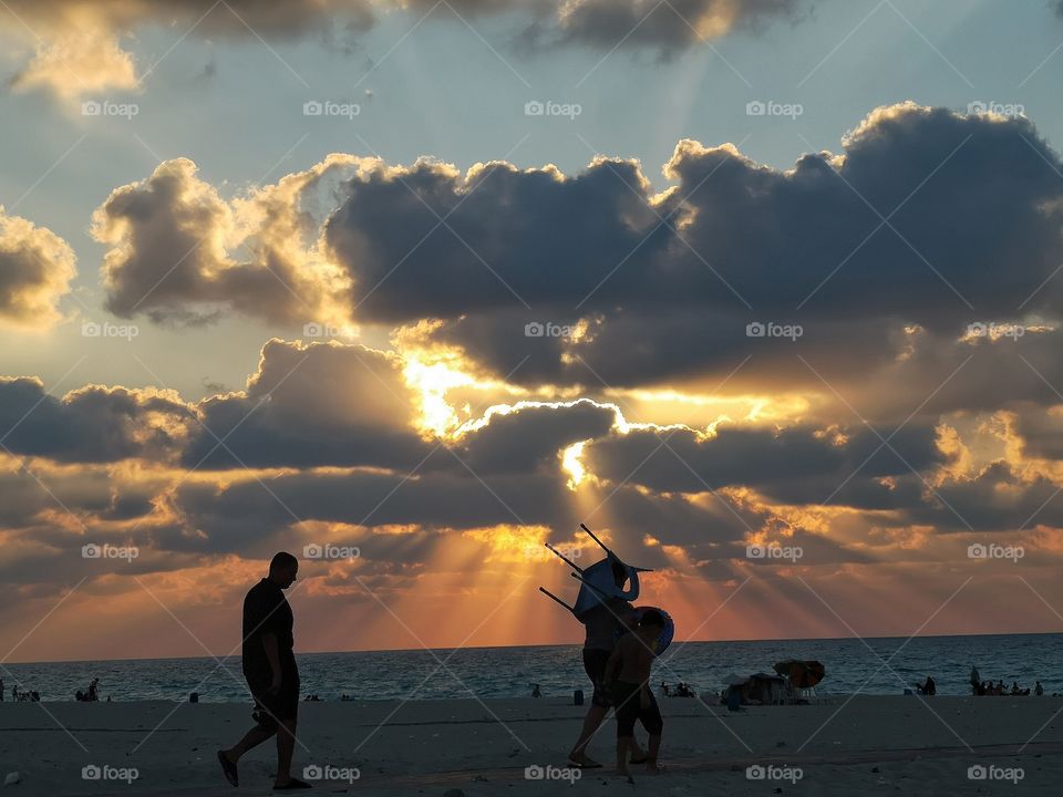 People walk to the beach.