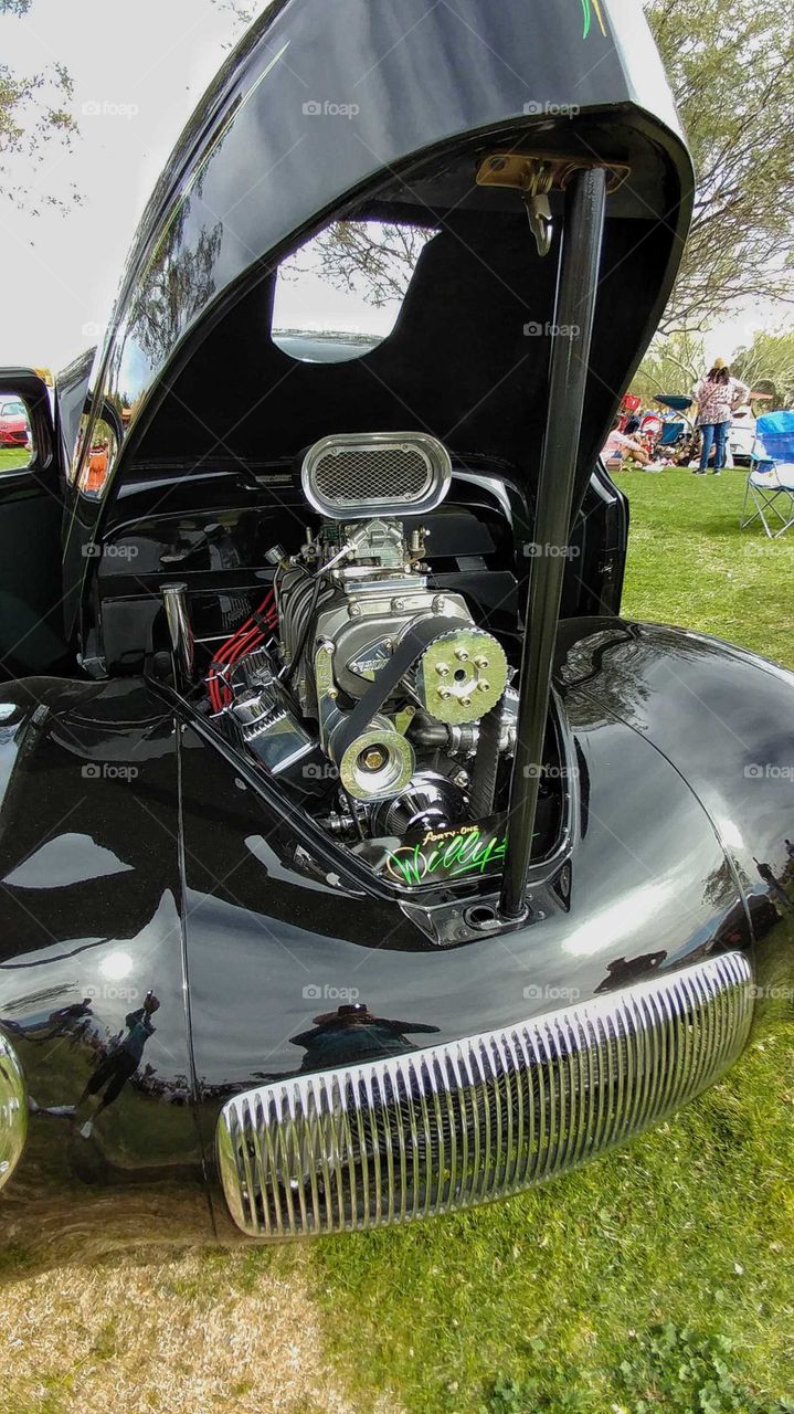 Engine of a custom built beautiful black Roadster.