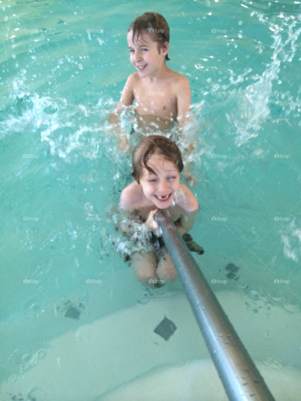 My two youngest boys having a blast at an indoor pool