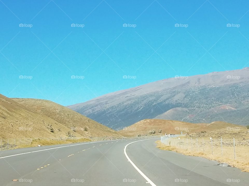 Empty road against blue sky