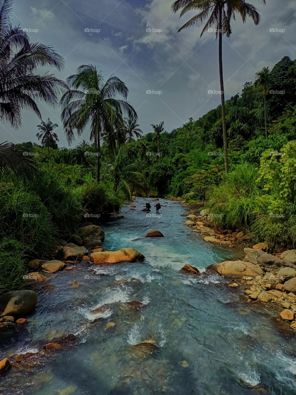 Panoramic landscape of bright blue river of dua rasa river and tropical rain forest