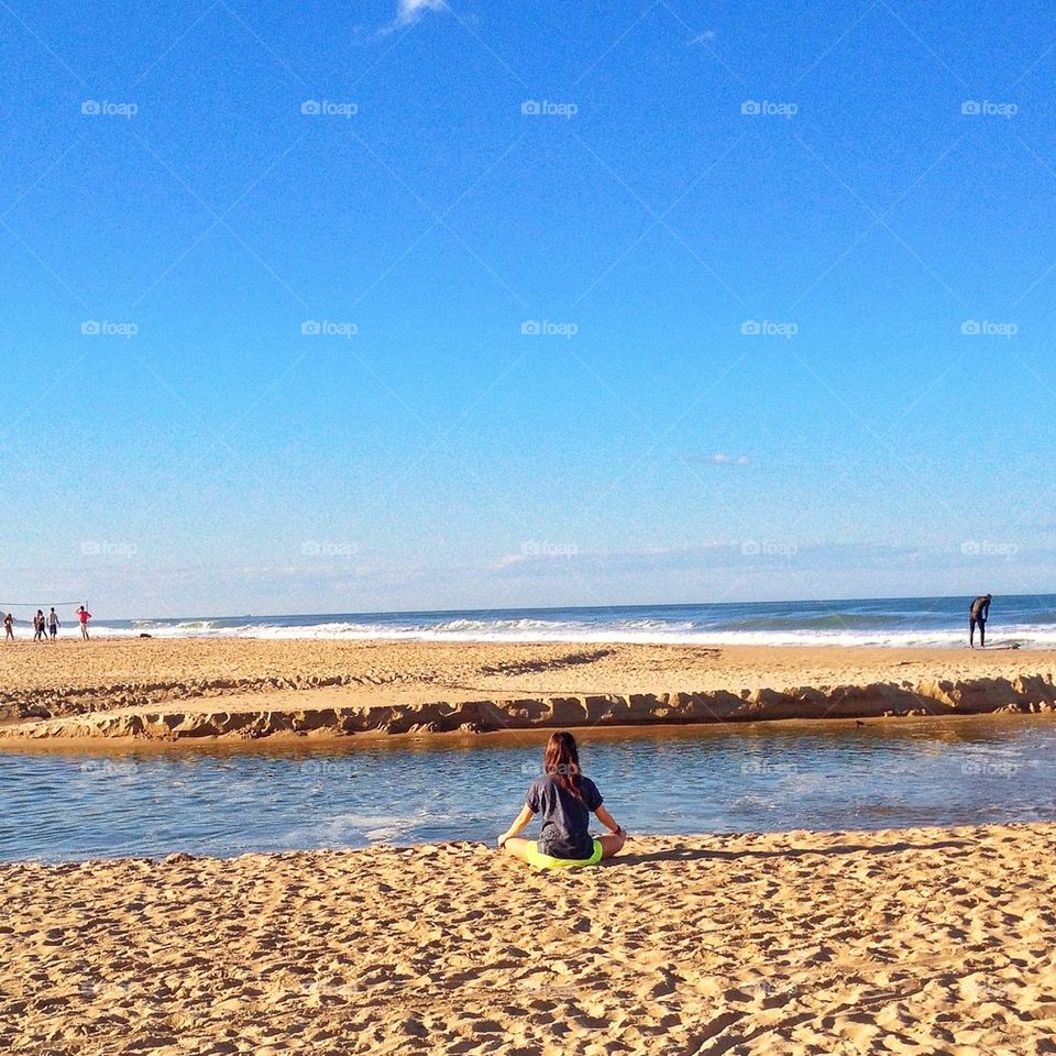 Girl meditating on the beach