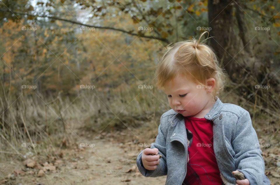 Close-up of a little girl standing in the forest