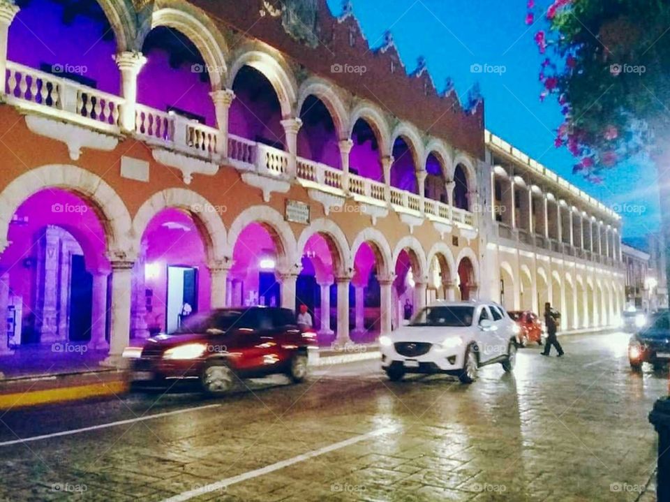 square in the center of the city at night illuminated and with traffic