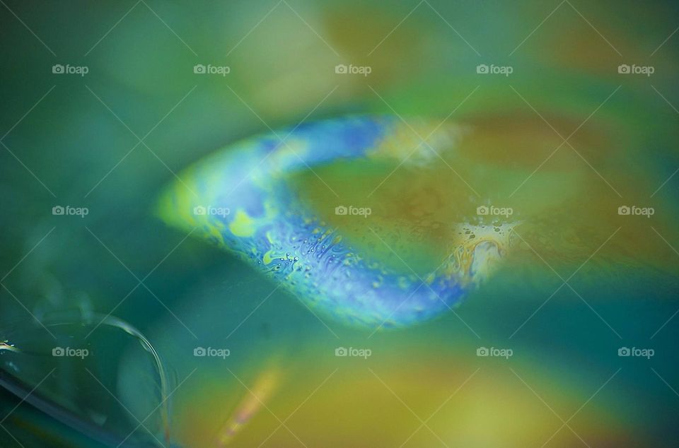 Macro photo of a water bubble with abstract shapes 