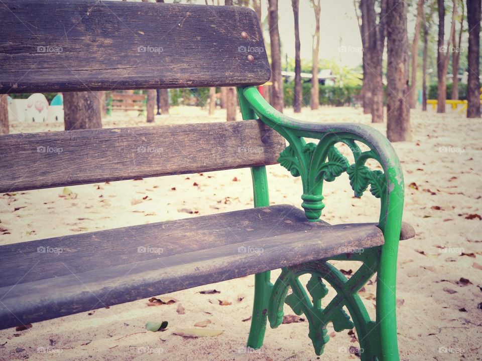 A sole empty and rustic bench in a park that represents my current feeling of being alone, sad and lonely.