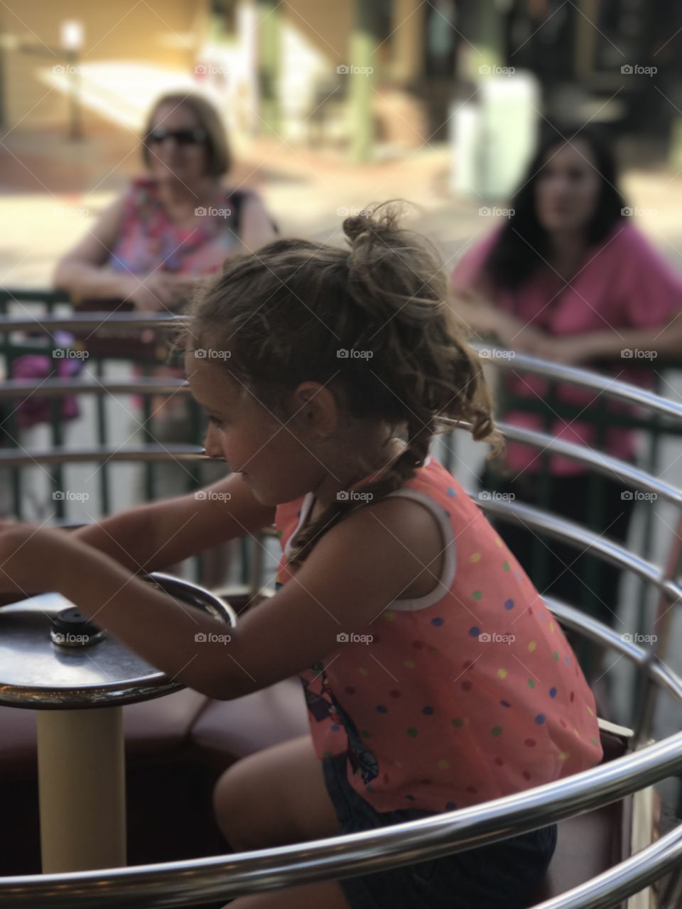 Little girl sitting near metallic railing