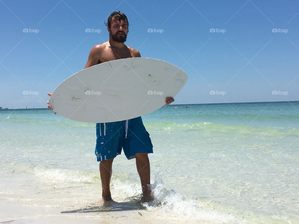 Surfer with skim board