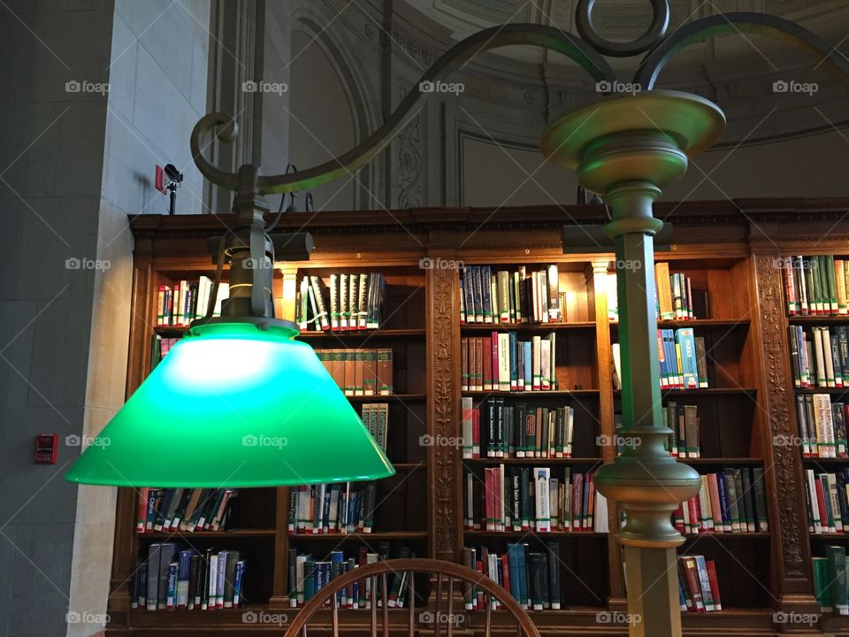 Study. A desk lamp and shelves in the reading room of the Boston public library.  