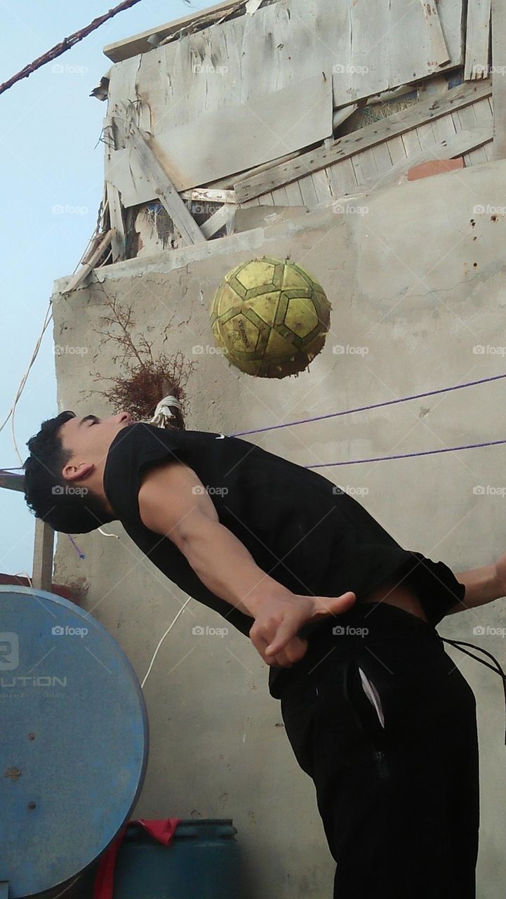 adult man play with a ball.