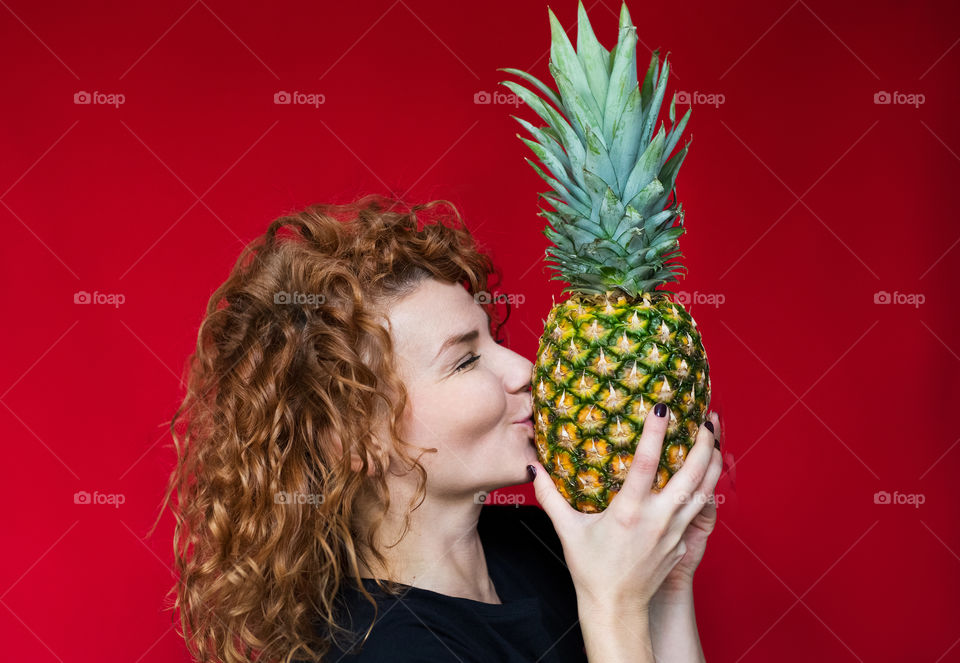 beautiful red-haired girl with pineapple with cool emotions