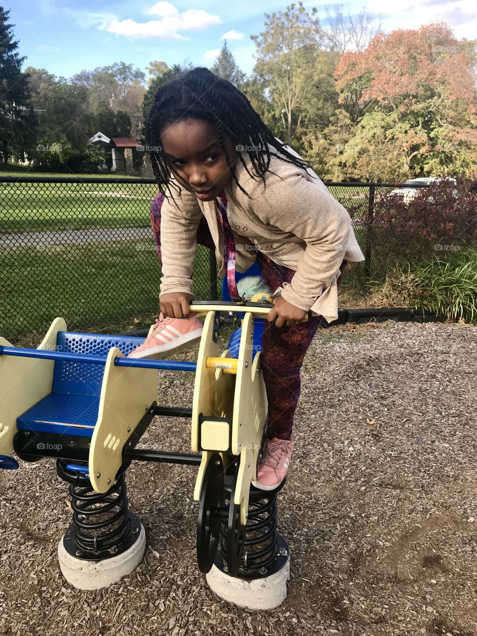 Child Climbing into ride-on toy playground 