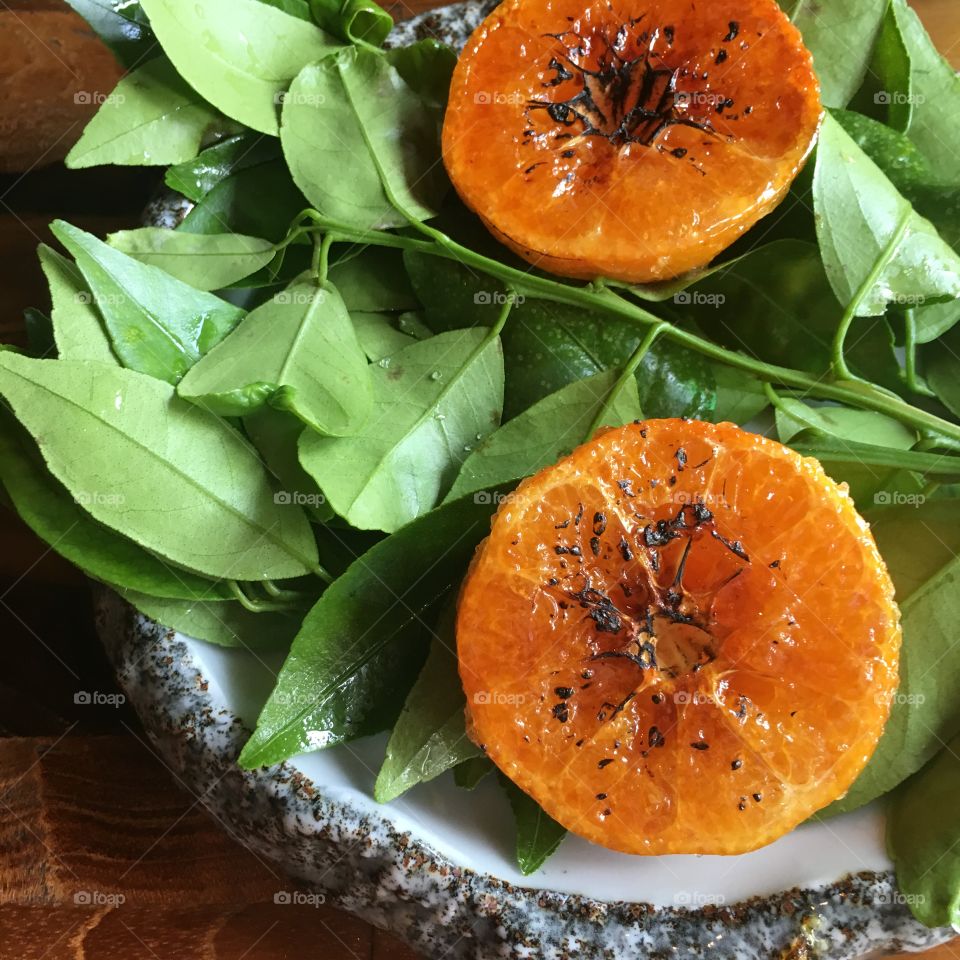 Caramelised oranges on a bed of lime leaves 
