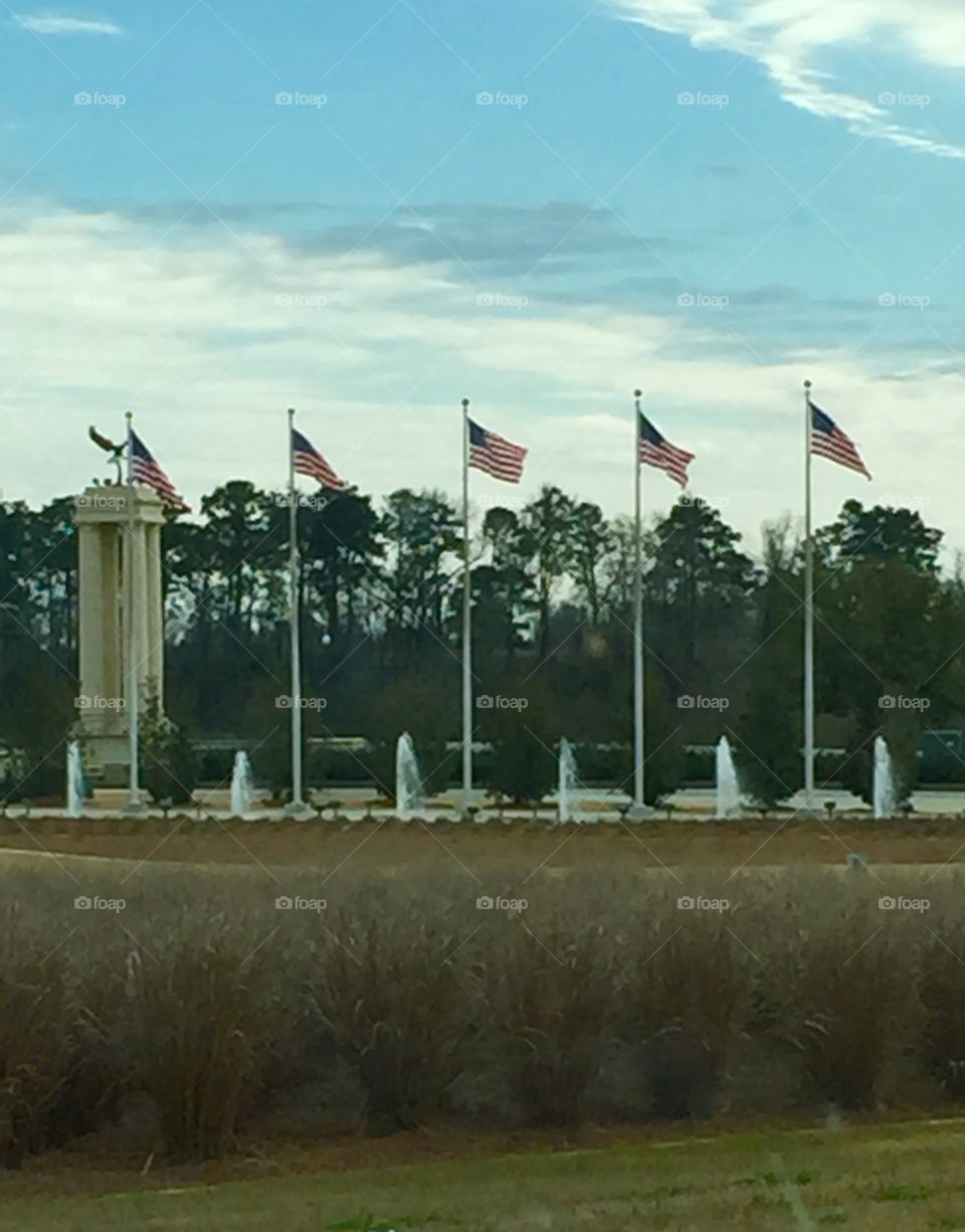 Flags flying near the road near a base.
