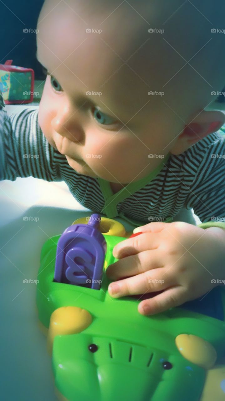 reaching..my grandson's first moment's with a toy❤