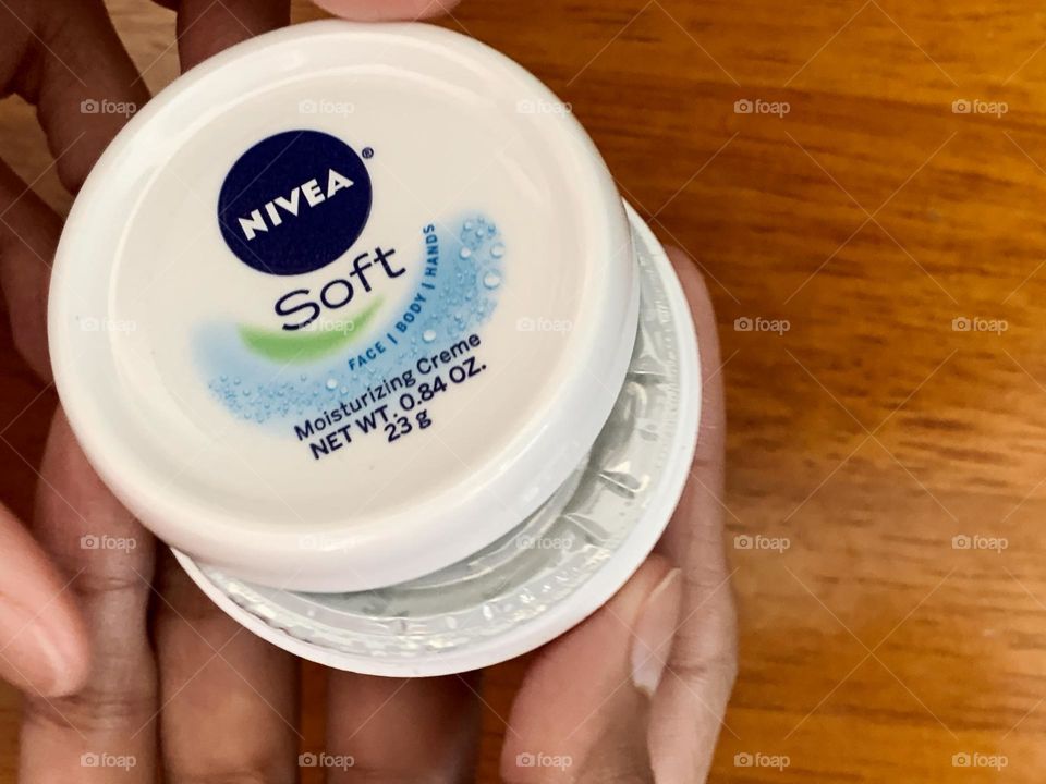 Opening the Nivea soft moisturizing creme