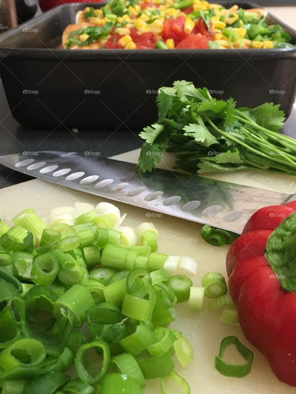 Food preparation, chopping, slicing spring onions, bell peppers capsicum, cilantro coriander 