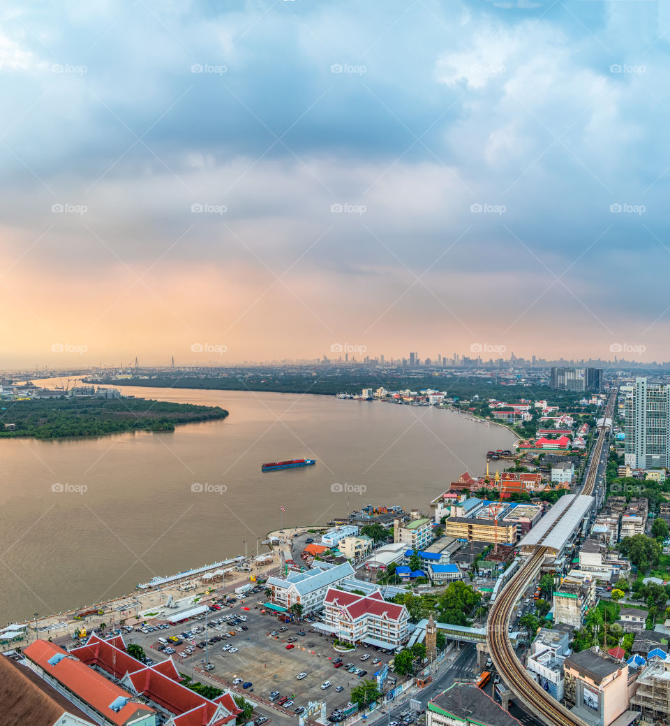 Bangkok city scape and boat in the river with beautiful sky background