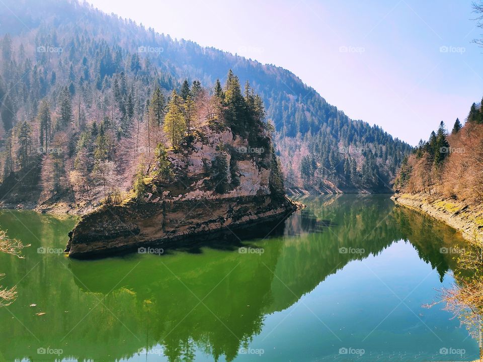 Little island in a lake in the mountains