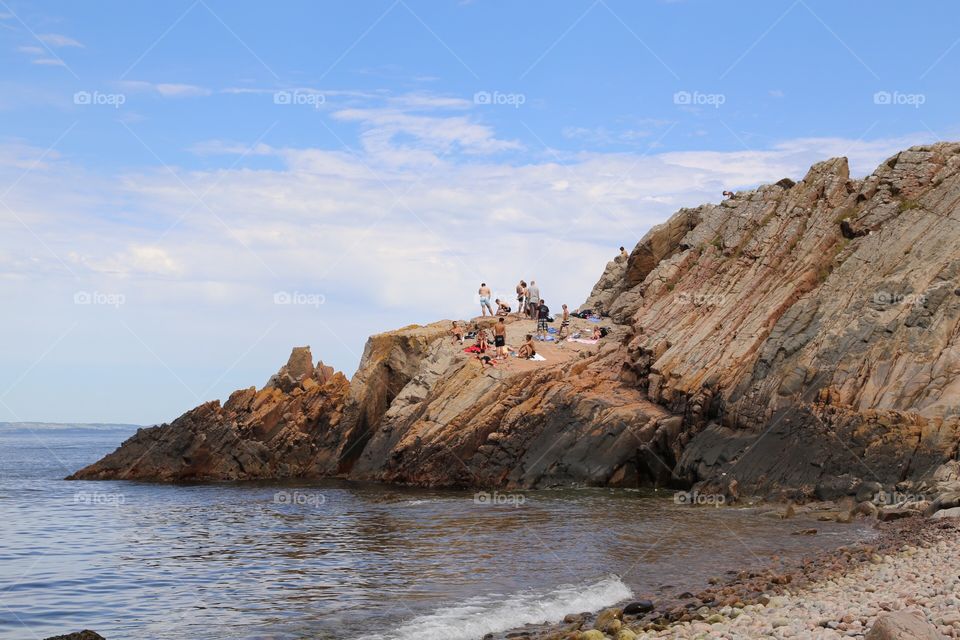 People on the rocky beach