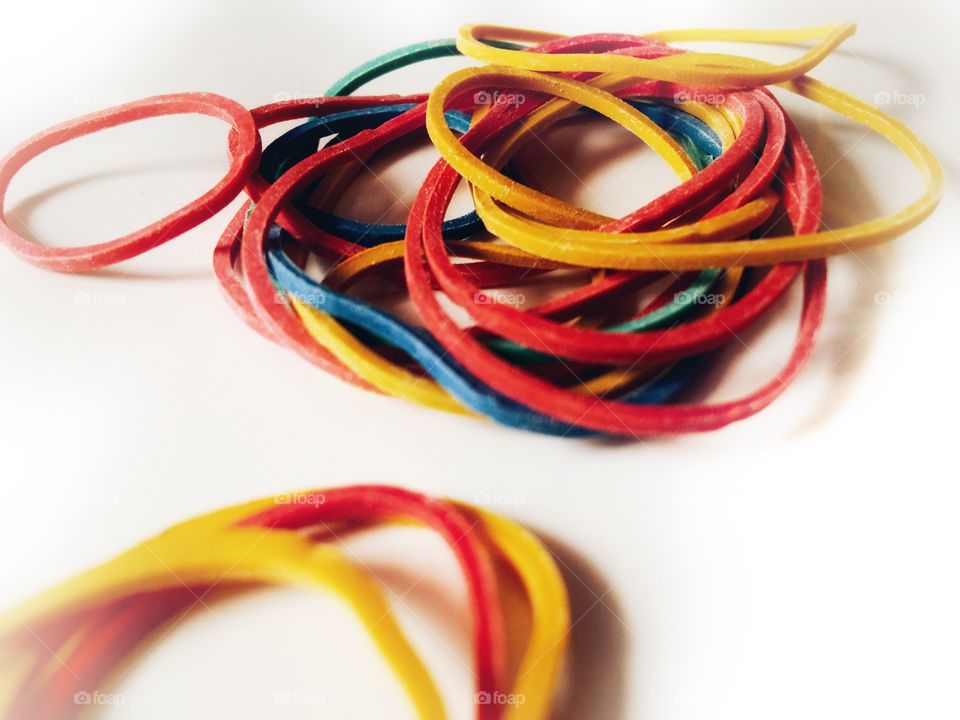 Bundle of rubber bands on white background 