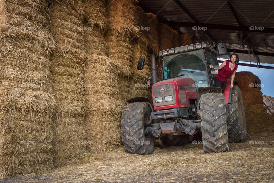 Hey piles and a tractor on a farm