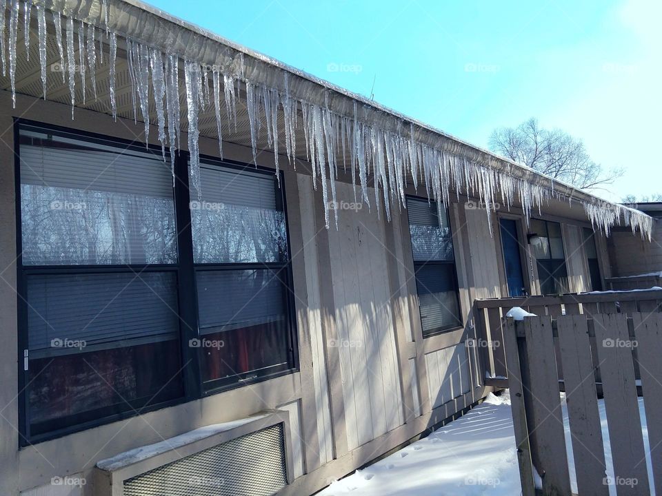icicles on roof after snow storm