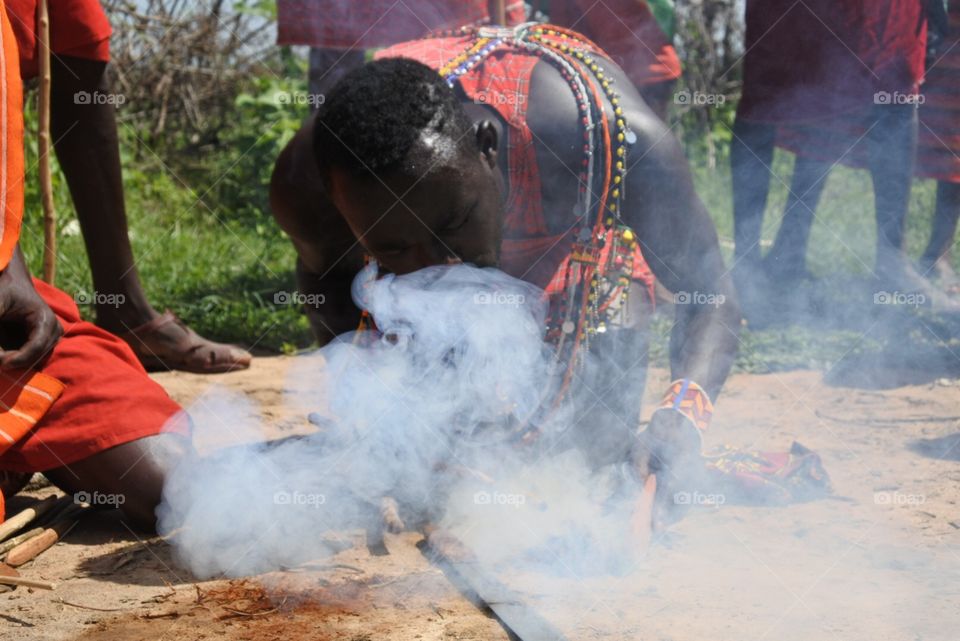 Let there be fire!. Massai man making fire.