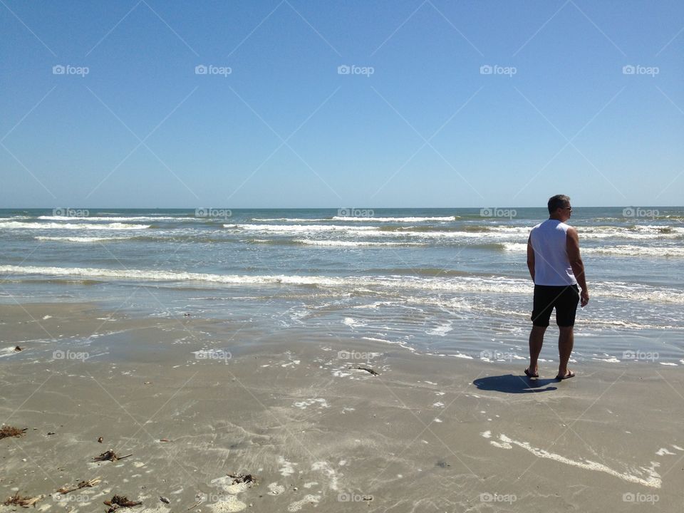 Rear view of man standing on beach