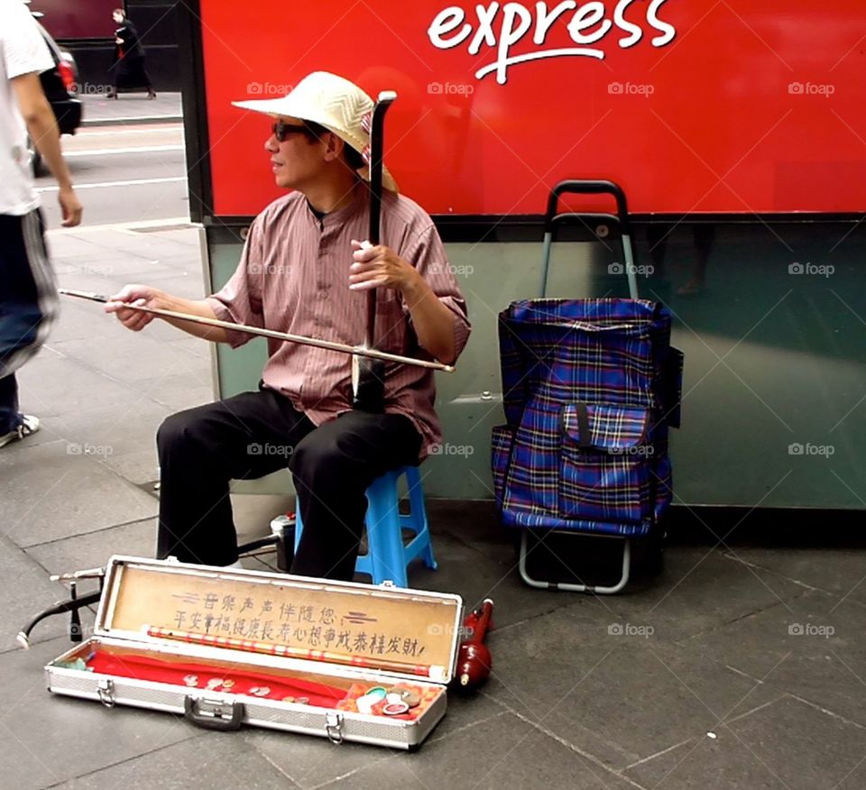 Australia. Street performer playing. 